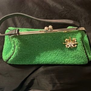Glenda Gies retro green handbag with antique stone pin attached.